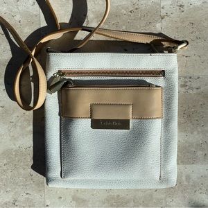 Tan and white colored Calvin Klein purse